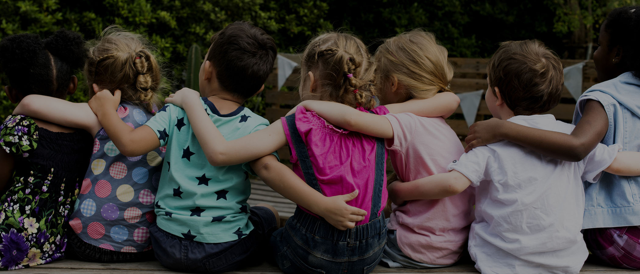 children hugging together-rear view