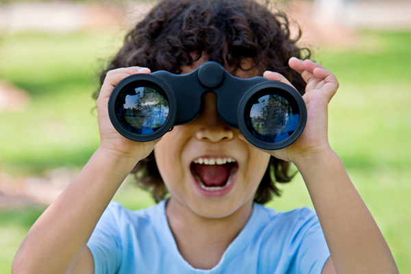 child looking though binoculars